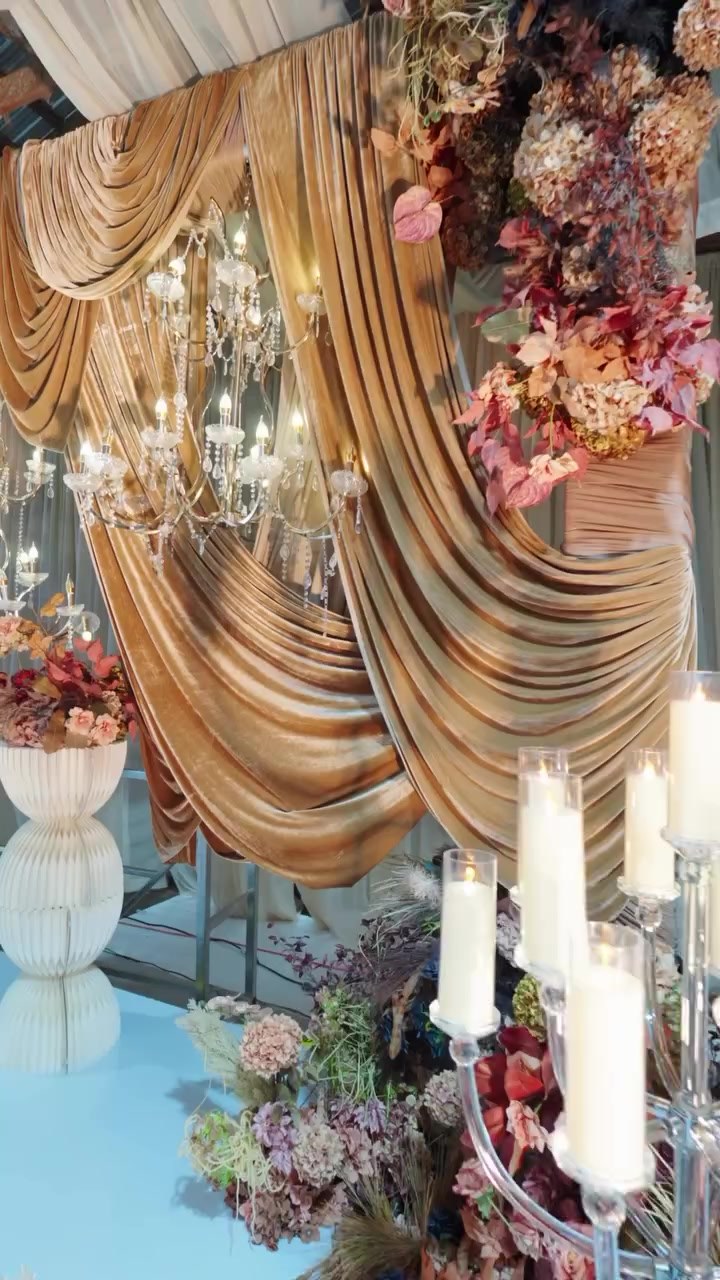 Chandelier and gold drapery details inside the reception hall at Amplify Venue